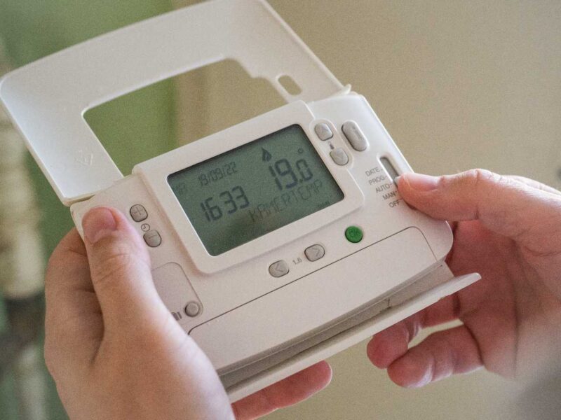 Person holding a thermostat