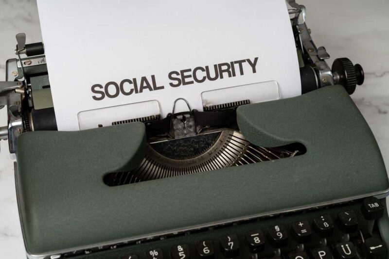 A typewriter with a piece of paper with the words Social Security typed on it in large font