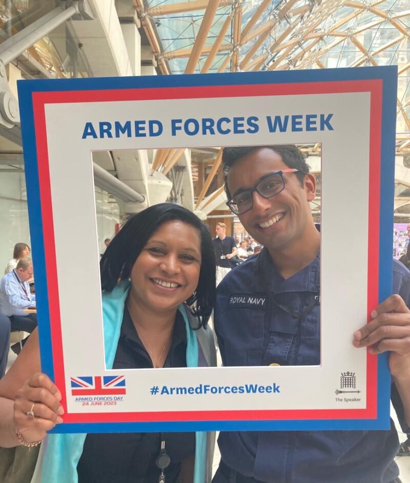 Janet Daby MP with a member of the Royal Navy holding a square cut out saying "Armed Forces Week"