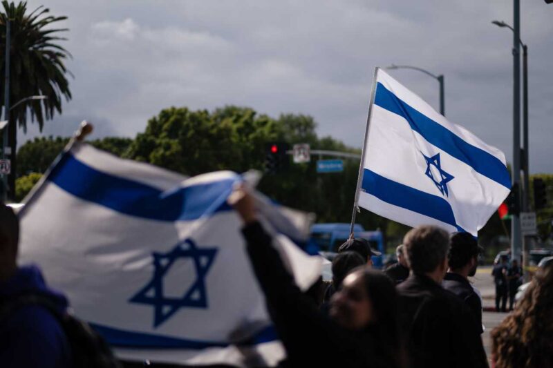 Picture of two Israeli flags among a group of people
