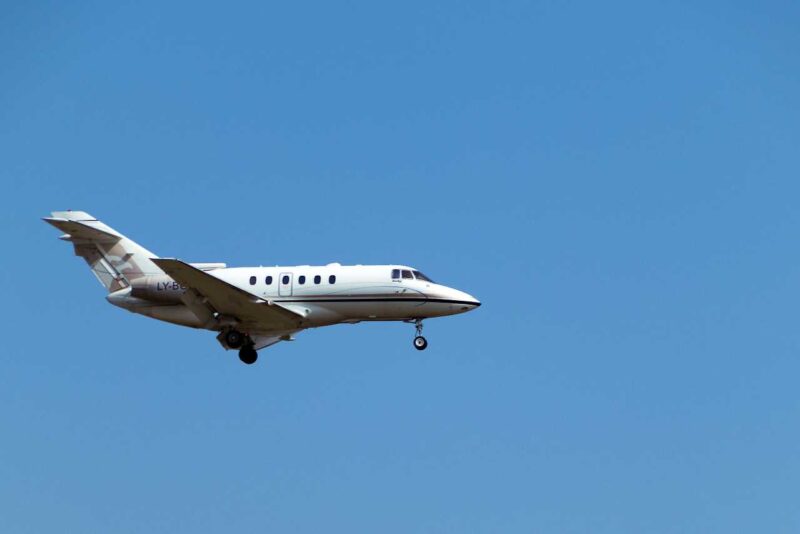 Private jet flying against the background of a blue sky