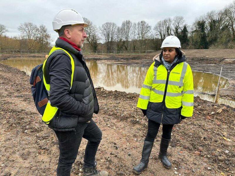 Janet Daby MP wearing a helmet and a high vis whilst being around building site to create a building the new playground, environment area, and café at Beckenham Place Park