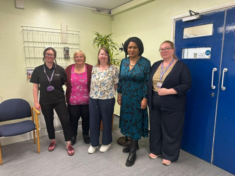 Janet stands with Beccy and Ruth from Imago, as well as two members of the peer support group